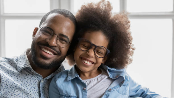 african father little daughter in glasses with toothy smile portrait - offspring child toothy smile beautiful imagens e fotografias de stock
