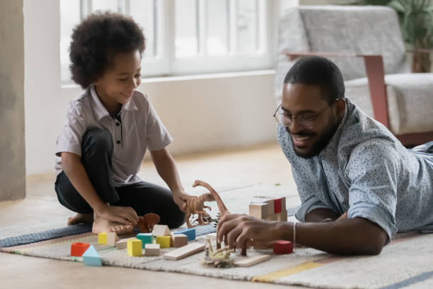 istock African father play with son on warm floor at home 1216562423