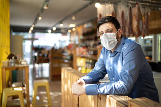 Portrait of small business man owner with face mask Portrait of small business man owner with face mask convenience store photos stock pictures, royalty-free photos & images