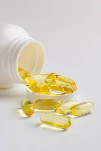 istock Fish oil capsules and bottle 1216566013