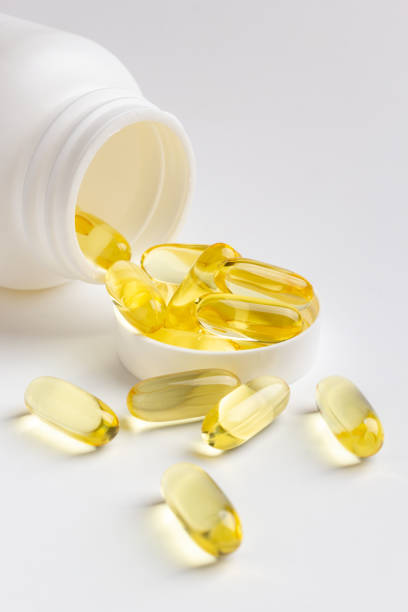 istock Fish oil capsules and bottle 1216566015