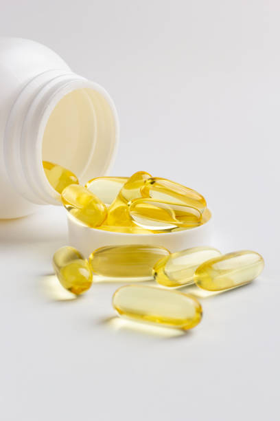 istock Fish oil capsules and bottle 1216566016