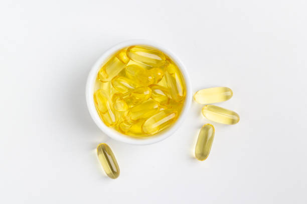 istock Fish oil capsules on white background 1216566029