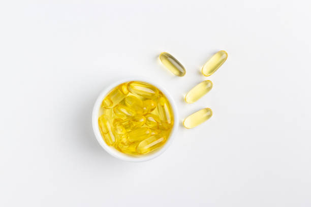 istock Fish oil capsules on white background 1216566036