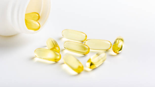 istock Fish oil capsules on white background 1216566041