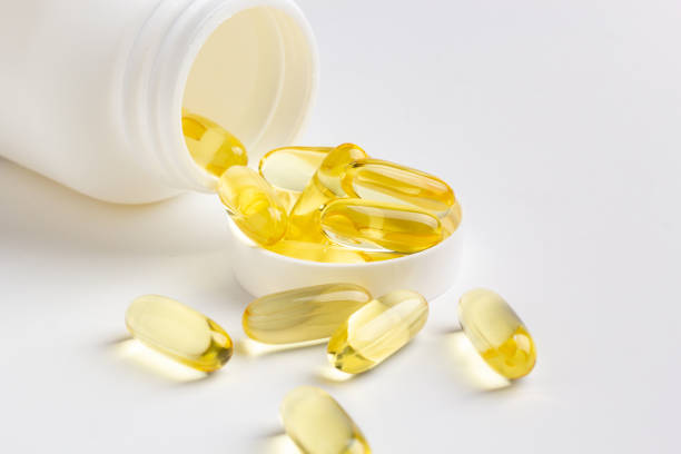 istock Fish oil capsules and bottle 1216566043