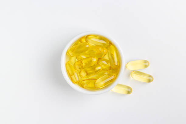 istock Fish oil capsules on white background 1216566051