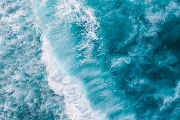 istock Big ocean waves hitting a coral rif. View from above. 1216566138