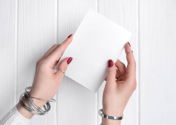 istock Womans hand with minimal pink spring summer manicure design holding greeting card. 1216566959
