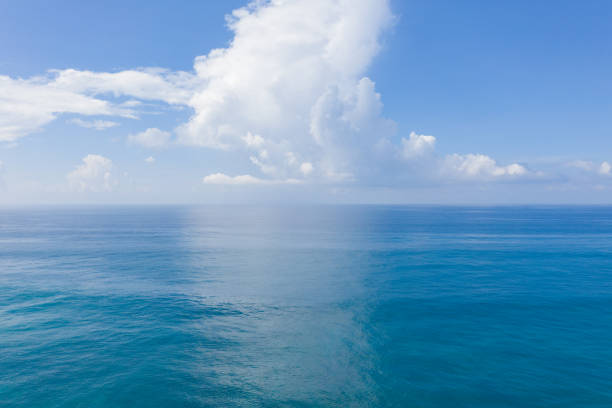 istock Fluffy clouds over the sea horizon 1216566985