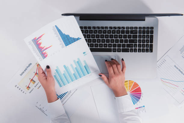 istock girl working with charts and graphs 1216567018