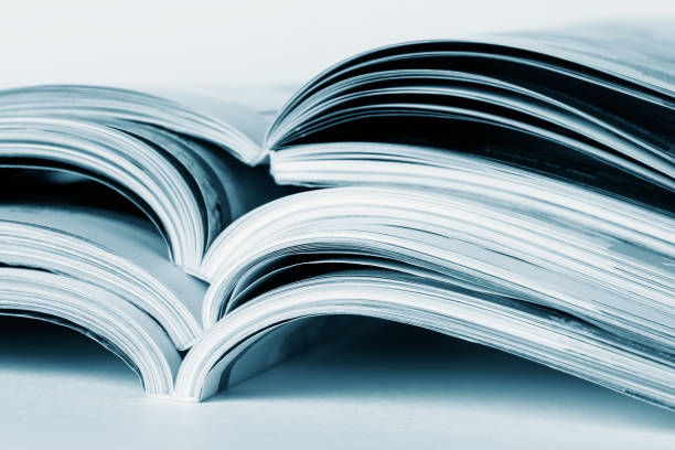 istock Pages of an open magazine, close-up, toning in blue. Selective focus. 1216567372
