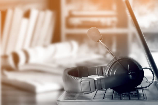 istock Coffee table with laptop and headset. The concept of remote work at home. Soft focus. 1216567468