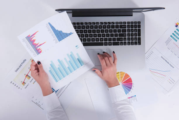 istock girl working with charts and graphs 1216569010