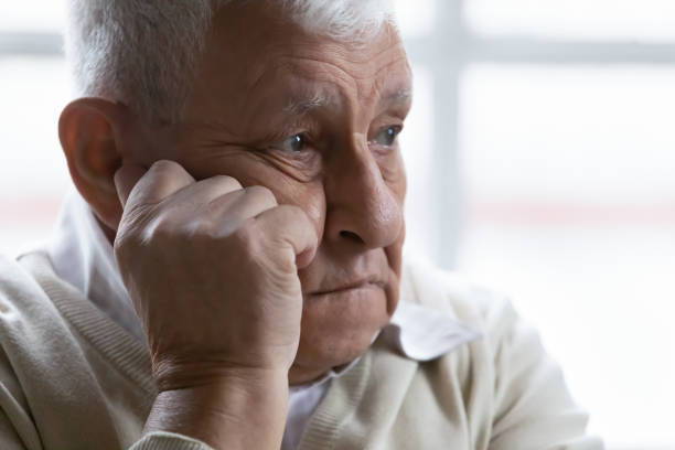 istock Closeup old man feeling disappointed and lost in sad thoughts 1216570455