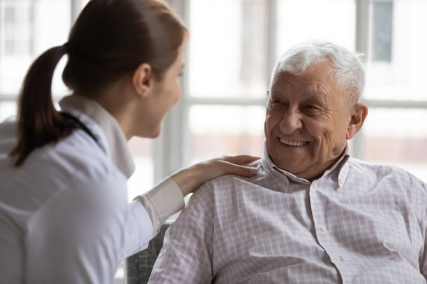 istock Caring geriatric nurse in white coat cares for elderly man 1216570522