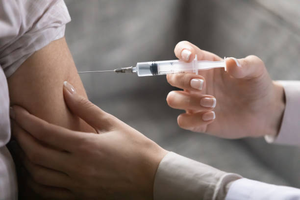 istock Closeup image hands of nurse makes injection to patient 1216570536