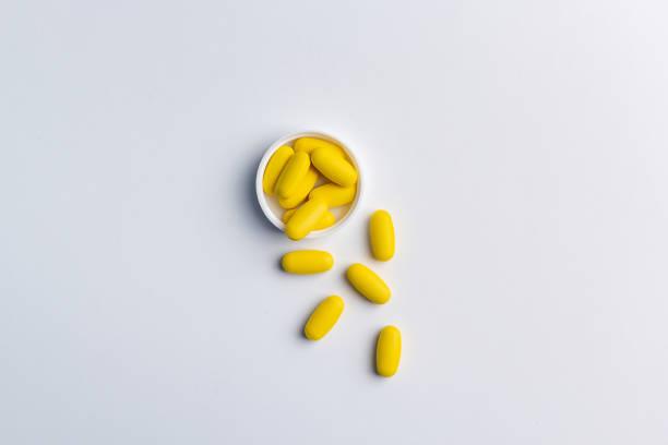 istock Yellow pills on white background 1216570728