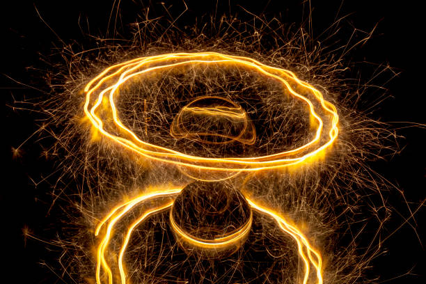 Light painting around a glass ball Abstract light painting with a sparkler circling around a glass ball on a black background. lightpainting stock pictures, royalty-free photos & images