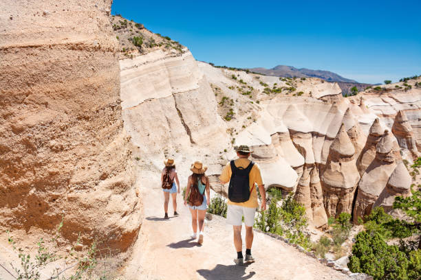 Family on summer vacation hiking trip in th emountains. People on summer vacation hiking trip. Family on hiking trip in beautiful mountains. Kasha-Katuwe Tent Rocks National Monument, near to Santa Fe, New Mexico, USA santa fe new mexico stock pictures, royalty-free photos & images