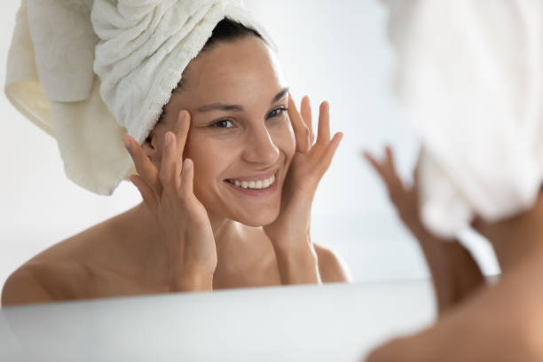 after beauty home procedure woman looking at skin feels satisfied - rebellion aging process facial mask beauty treatment imagens e fotografias de stock