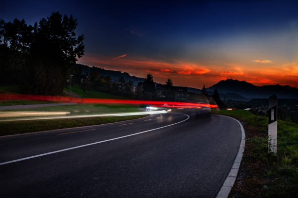 istock streaks of car lights during sun down 1216578420