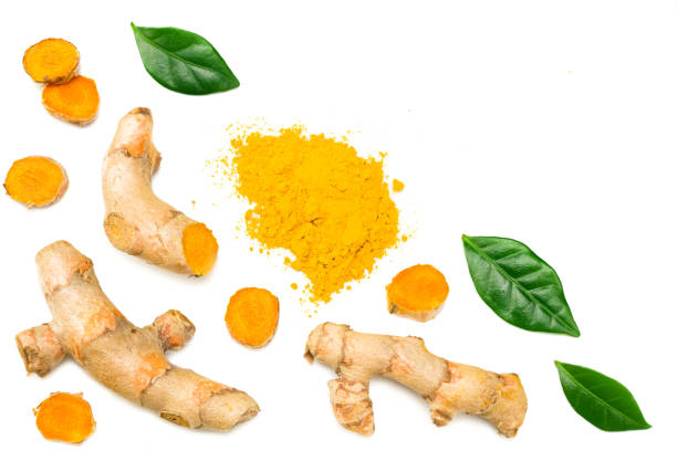 istock Turmeric powder with turmeric root isolated on white background. Top view. 1216578992