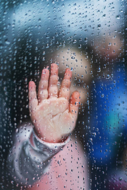 istock Girl With Hand on Window 1216579035
