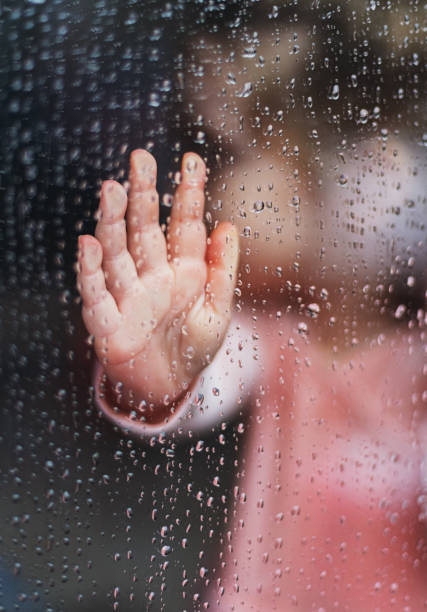 istock Girl With Hand on Window 1216579039