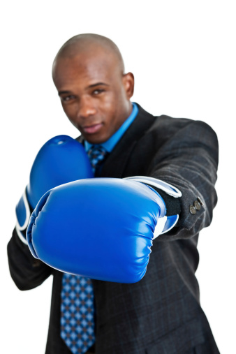 Man boxing wearing a suit selective focus on gloves