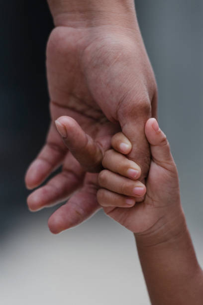 istock Mother's and a child hands 1216581989