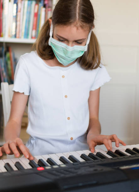 istock Little girl learning the piano during quarantine. 1216582420