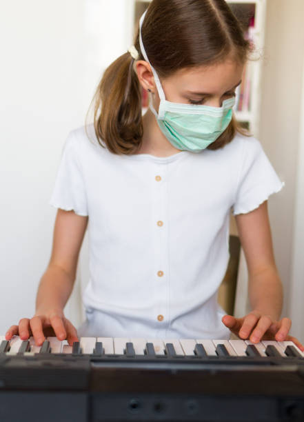 istock Little girl learning the piano during quarantine. 1216582448