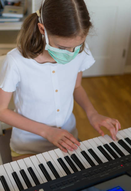 istock Little girl learning the piano during quarantine. 1216582456