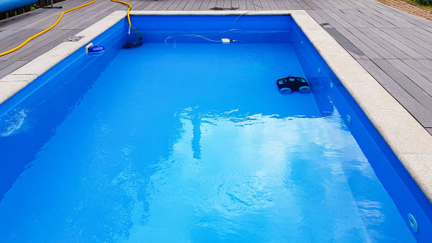 istock Swimming pool cleaner robot during vacuum service, maintenance. 1216583246