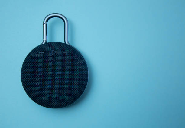 istock Modern portable speaker on blue background stock photo 1216584560