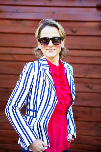 June 30, 2013 - Norway: pretty slim confident, smiling, blond business woman in white jacket, ed blouse, sunglasses posing for a formal portrait.