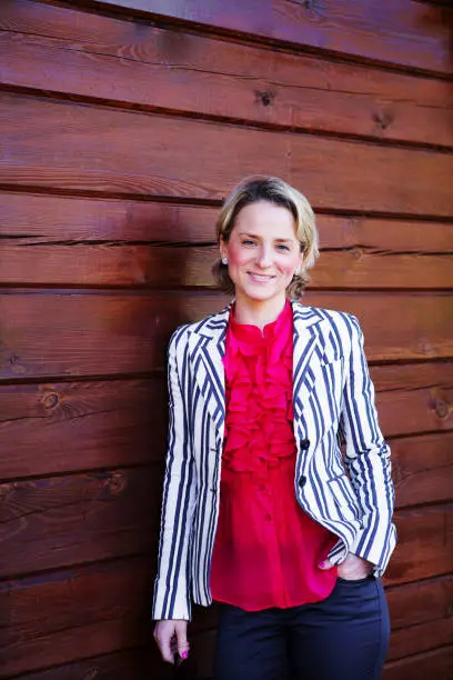 June 30, 2013 - Norway: confident relaxed young woman in formalwear, short hair, blonde, looking at camera standing outdoors