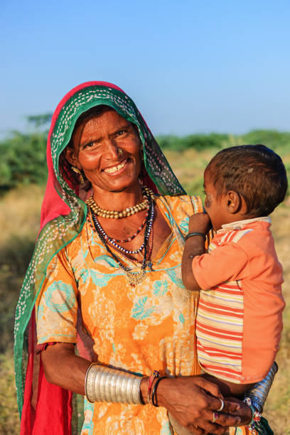 istock Indian woman holding her child 1216587739