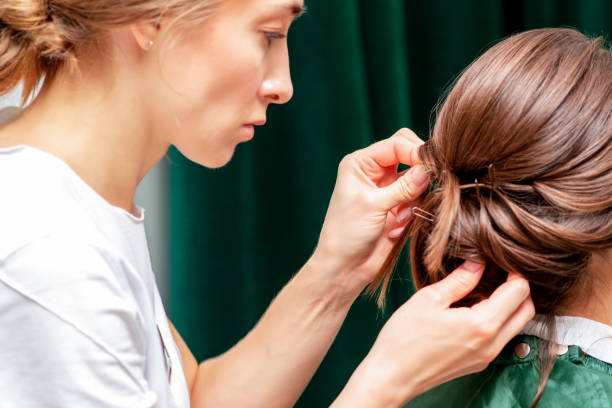 istock Hairdresser makes hairstyle. 1216588002