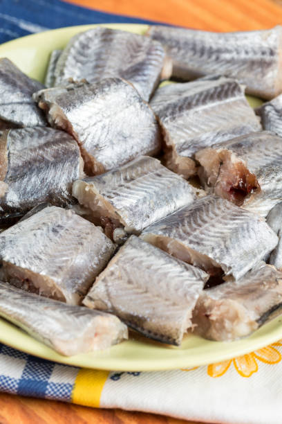 Sliced fresh raw hake fish on the plate Sliced fresh raw hake fish on the plate. merluza stock pictures, royalty-free photos & images