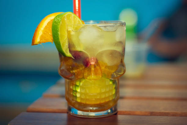 istock Caipirinha drink with lemon and orange in a skull-shaped cup. 1216589896