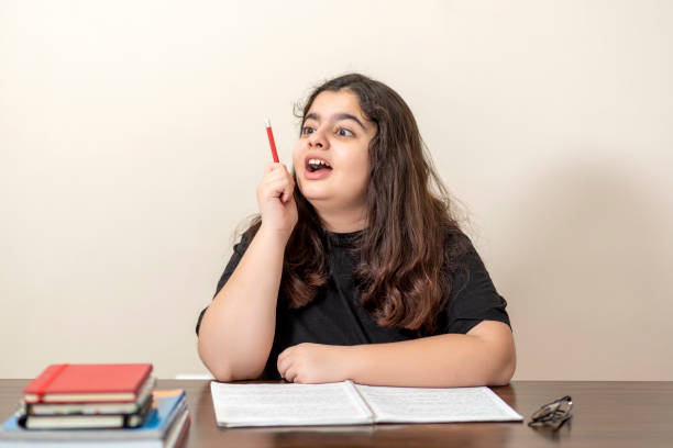 istock 13 years old girl doing homework 1216592060