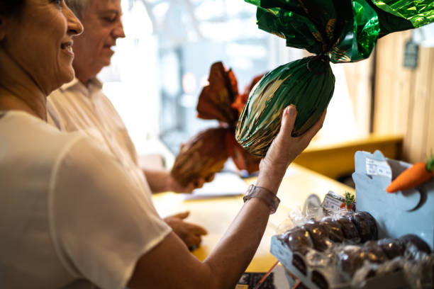 Senior couple buying easter egg in a store