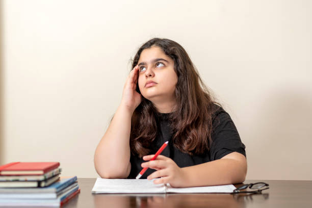 istock 13 years old girl doing homework 1216592126