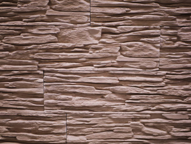 istock uneven stone facade close-up. Torn stone texture. Stone wall. Stonewall abstract background 1216593406