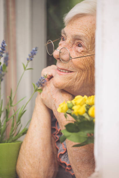 Senior woman behind the window