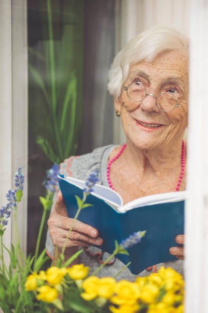 istock Senior woman behind the window 1216593783
