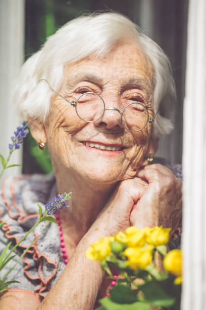 istock Senior woman behind the window 1216593891