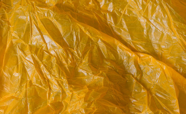 istock orange wrinkled foil bag. texture or background 1216594916